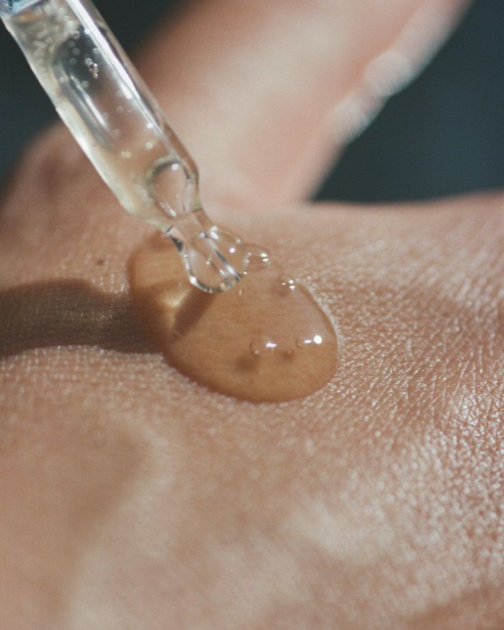 Treatment room with a white bed, decorative plants, and a bright light.