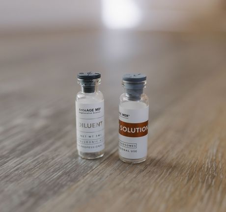 Two small glass vials labeled 