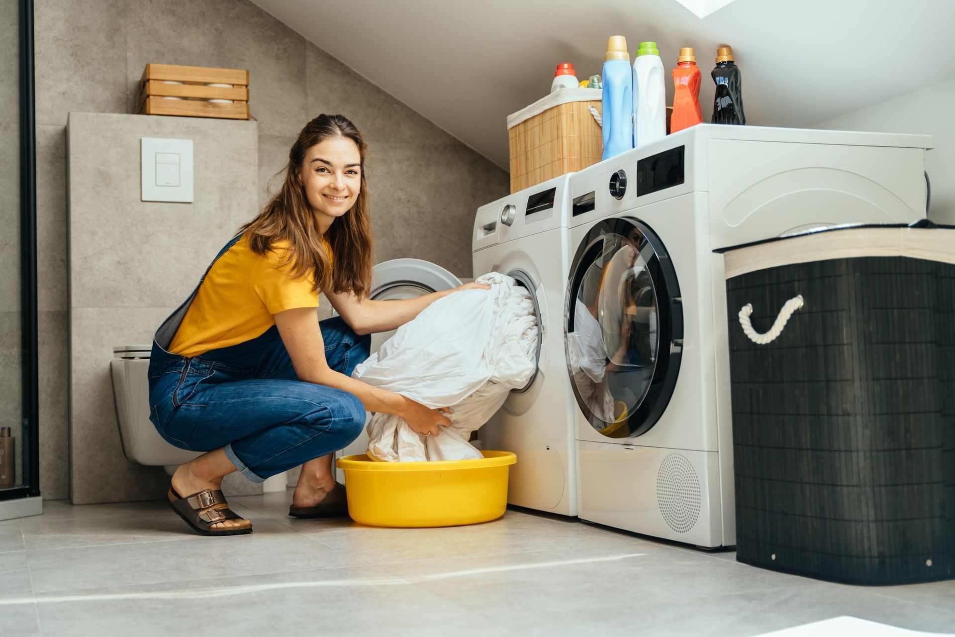 A laundry room with hotel towels being washed.