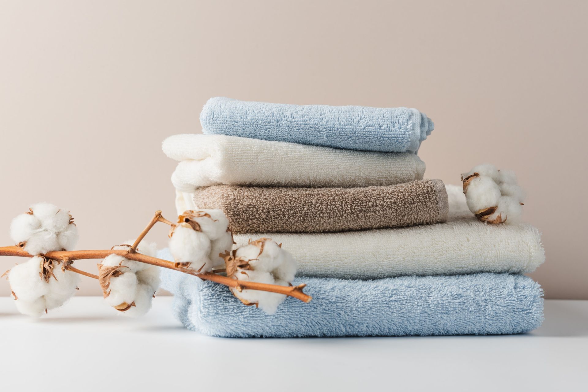 An illustration explaining GSM in towels, showcasing different types of towels.