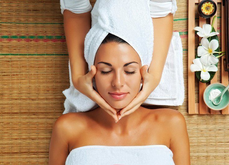 A lady being massaged wearing a spa towel
