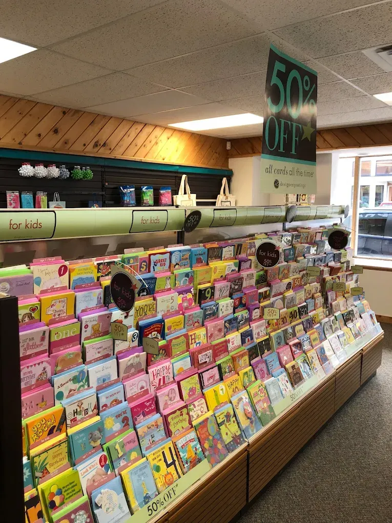 A store filled with lots of greeting cards and a sign that says 50 % off