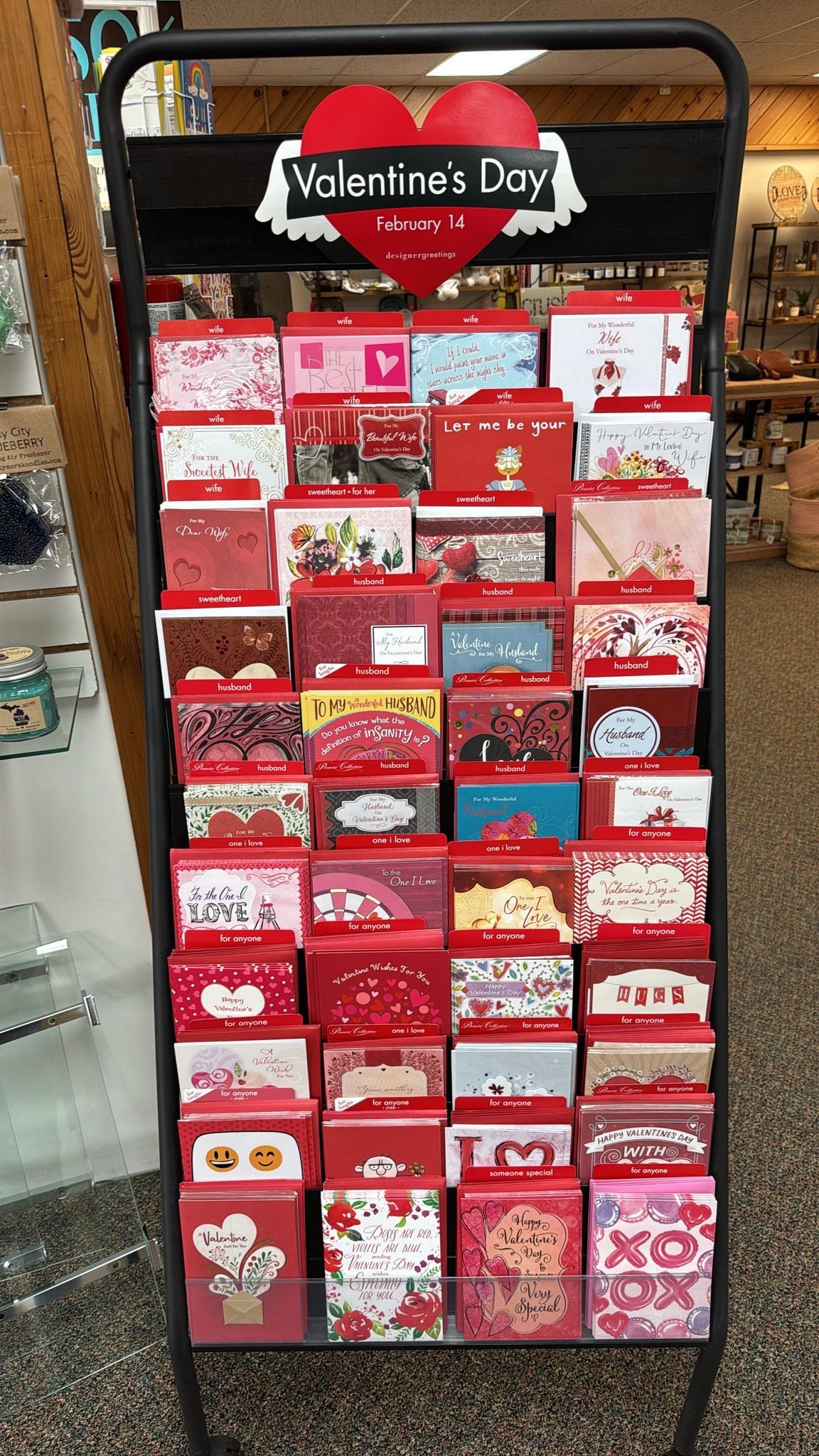 A display of valentine 's day cards in a store.