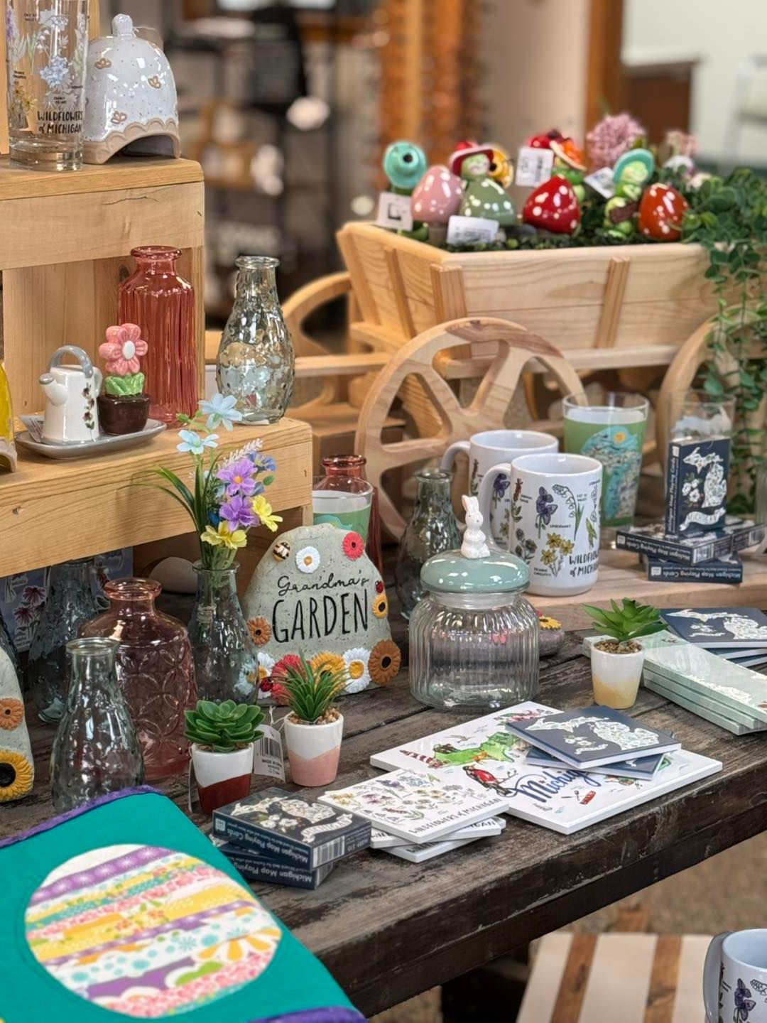 A table filled with lots of vases and potted plants.