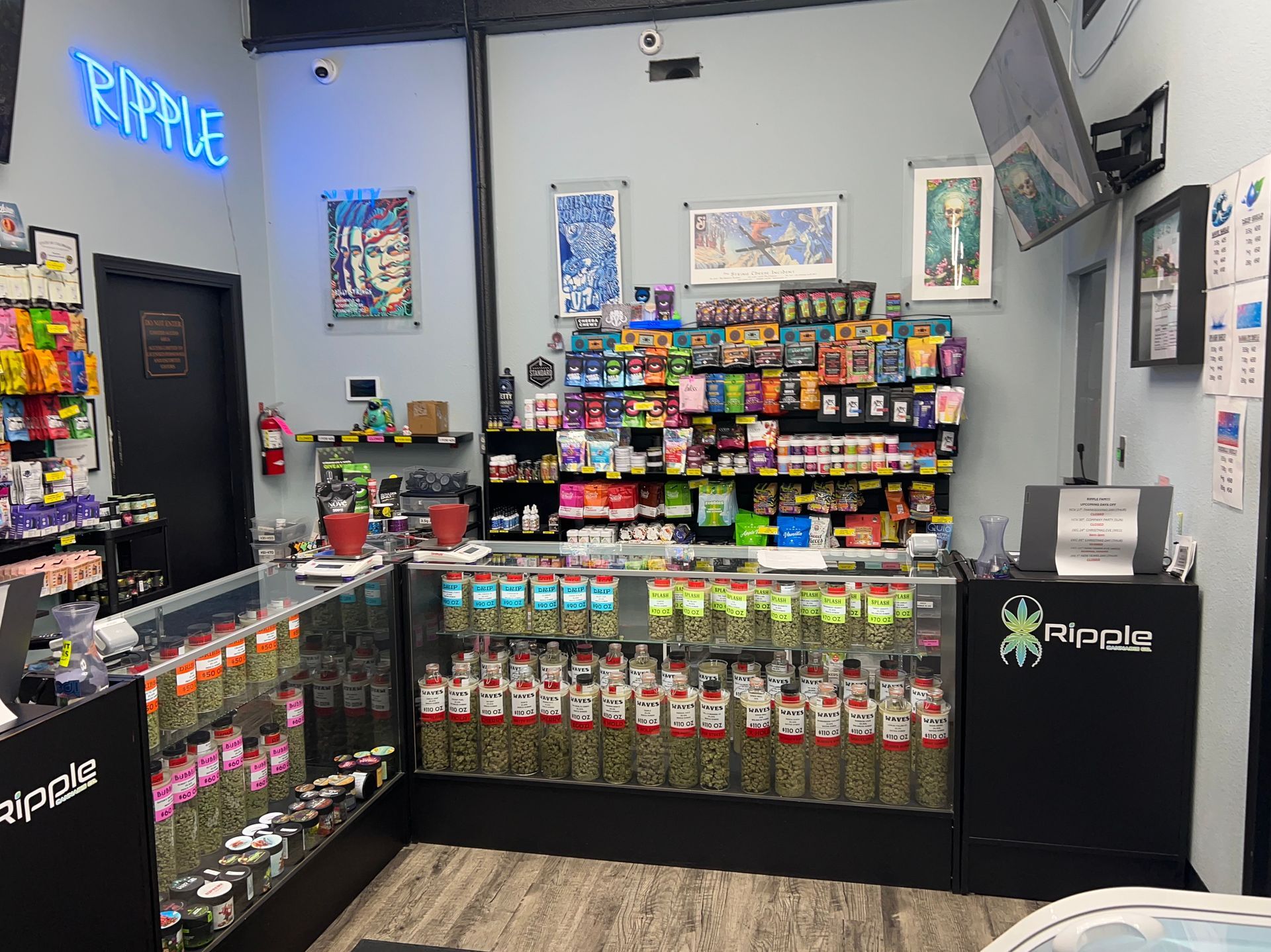Interior of a cannabis dispensary, showcasing products behind glass counters and on shelves.
