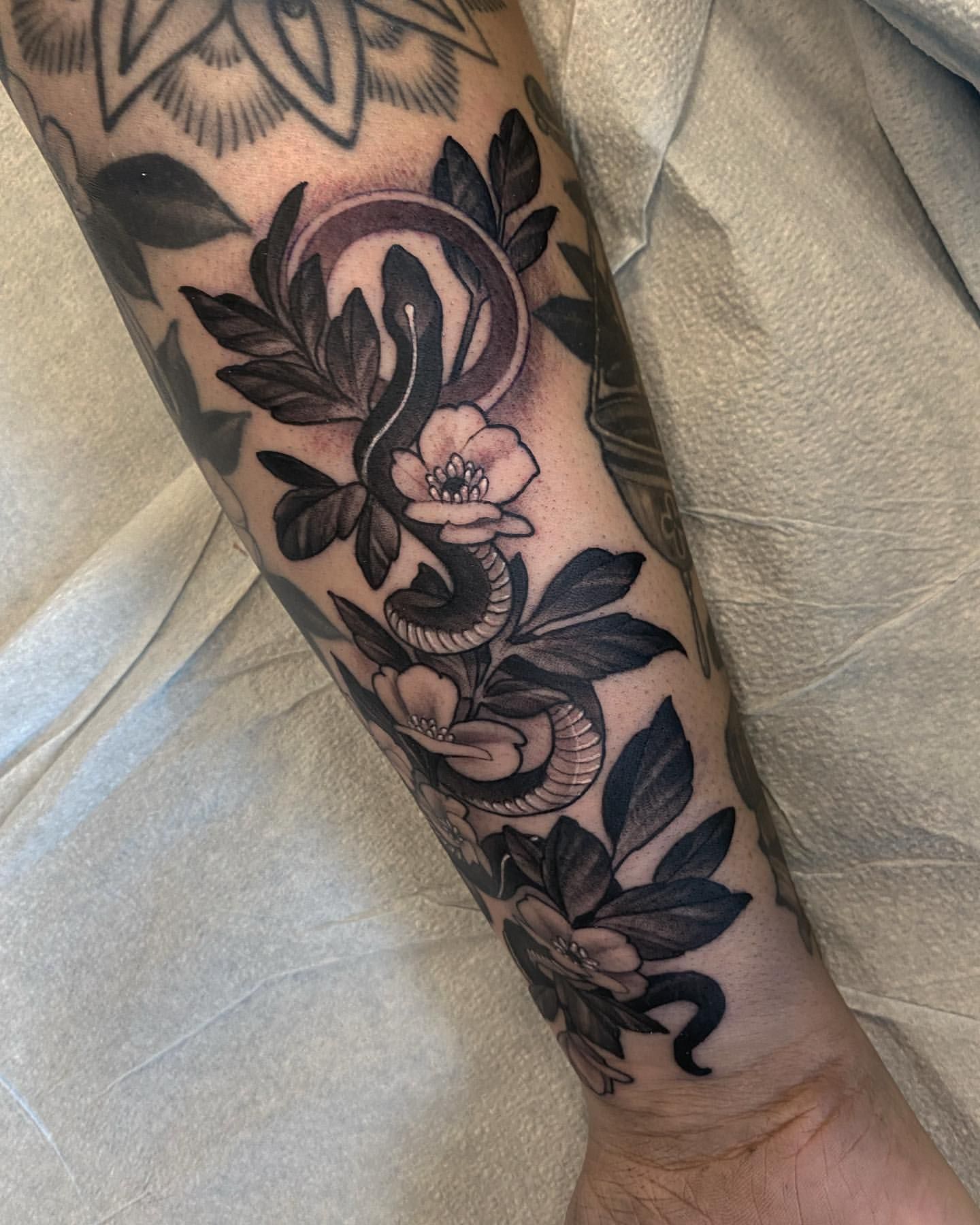 Snake and Floral Tattoo by Sasha Day at Crimson Empire Tattoo in Edmonton Alberta Canada