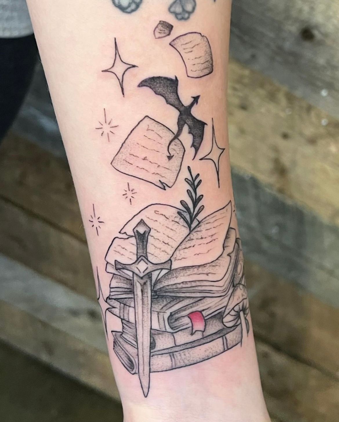 Books, Sword and Dragon Tattoo by Vanessa Spezowka at Crimson Empire Tattoo in Edmonton Alberta Canada