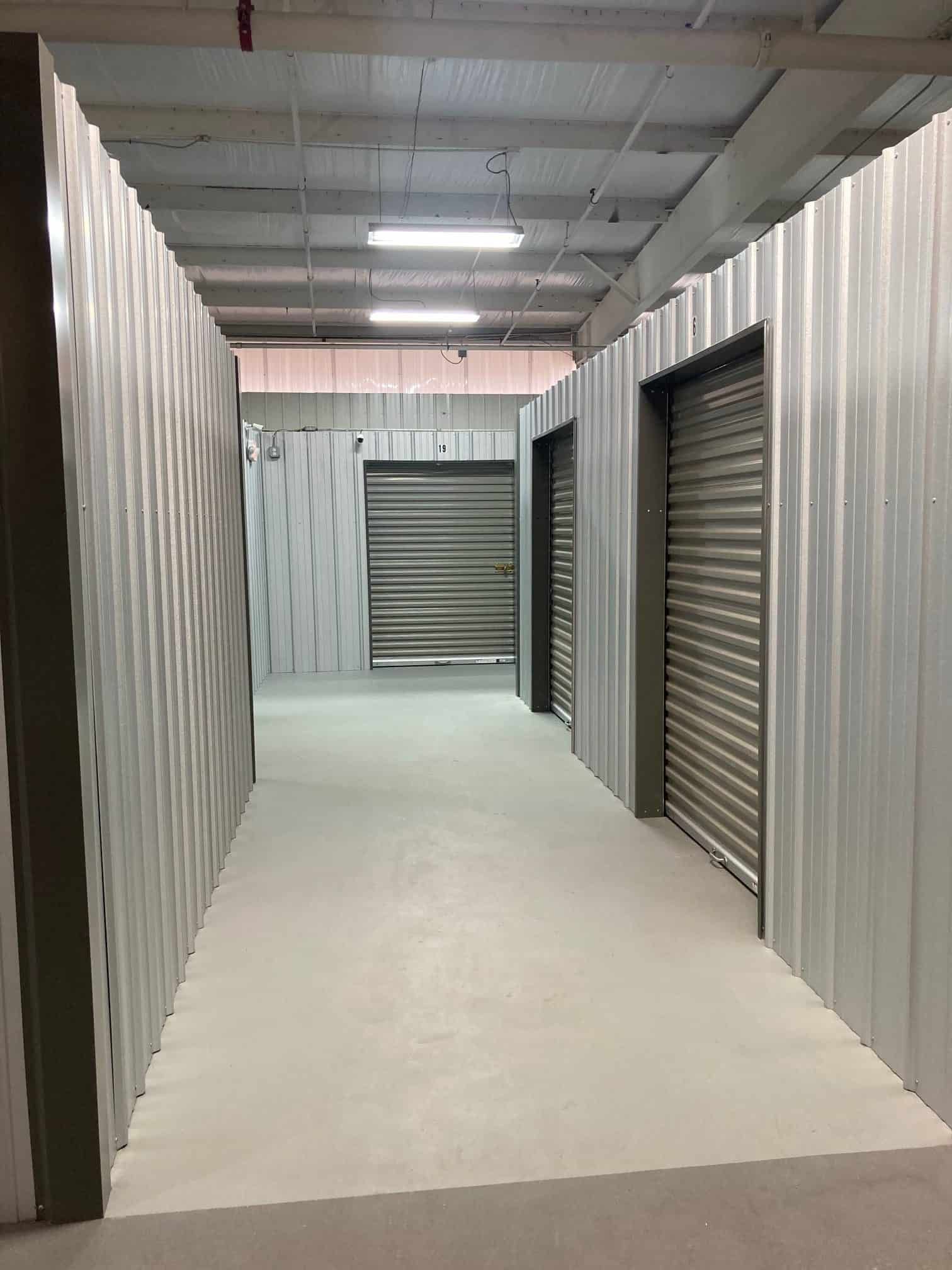 A long hallway with a lot of doors in a building