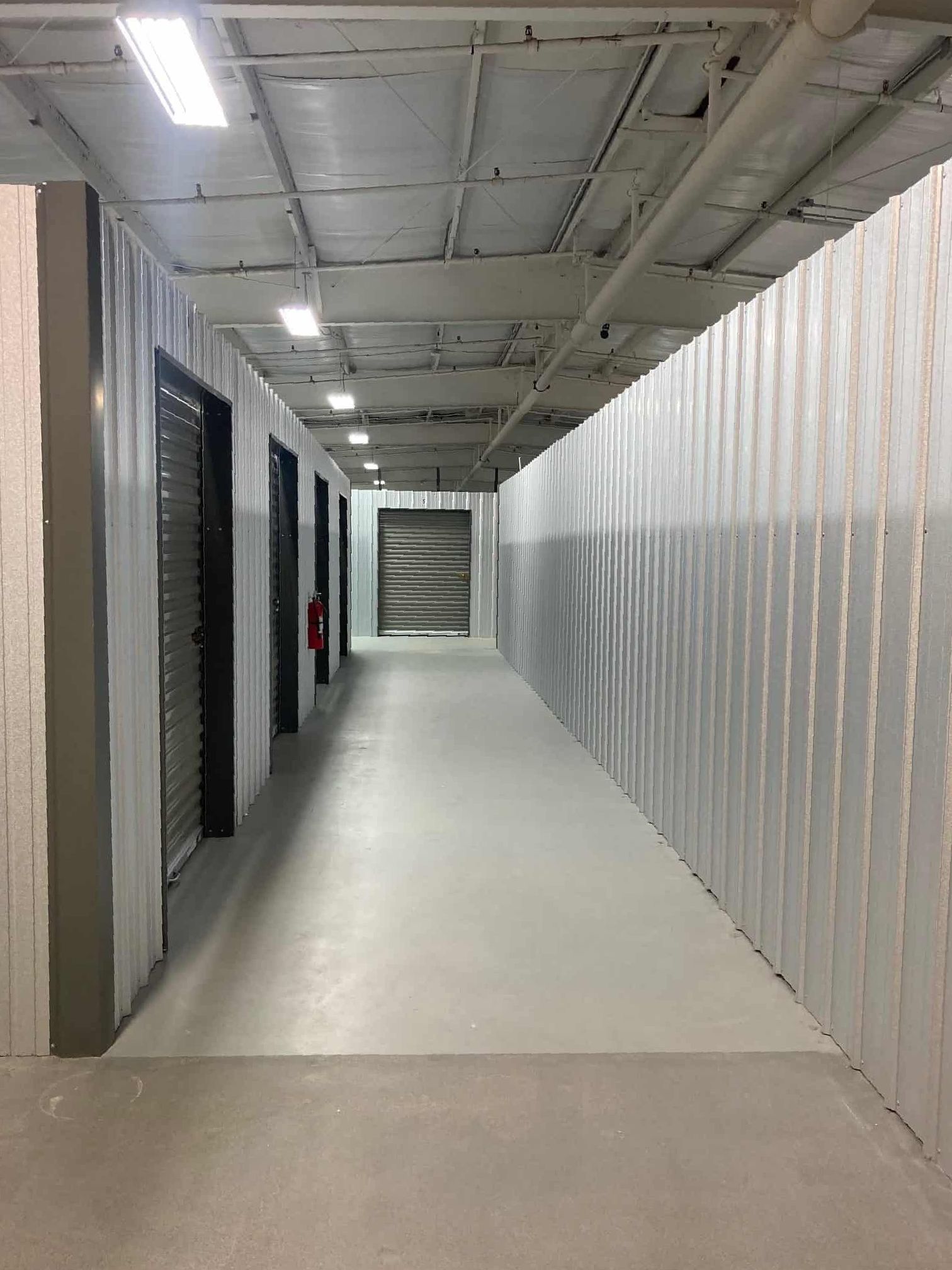 A long hallway with a lot of doors in a building.