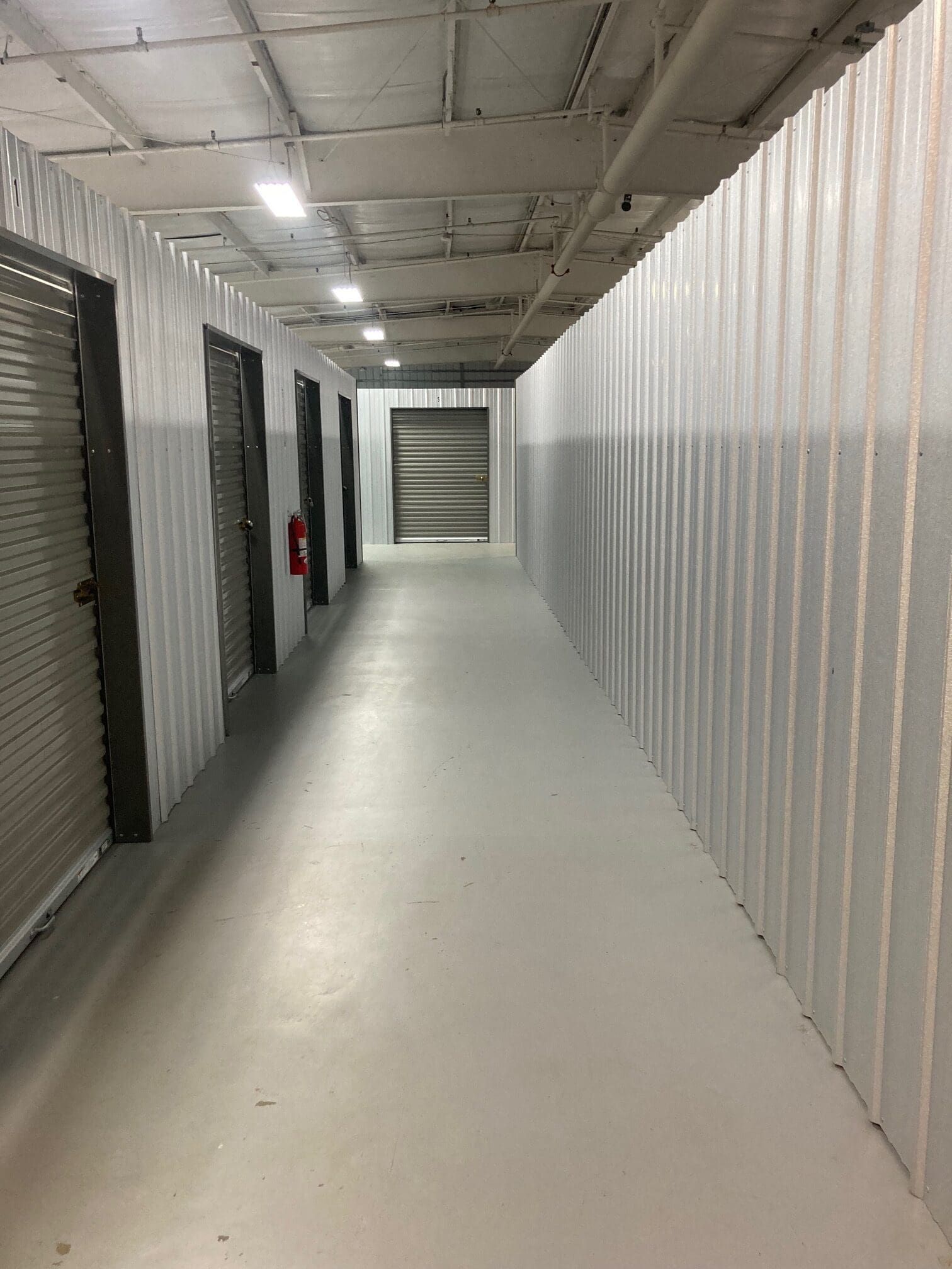 A long hallway with a lot of doors in a building.