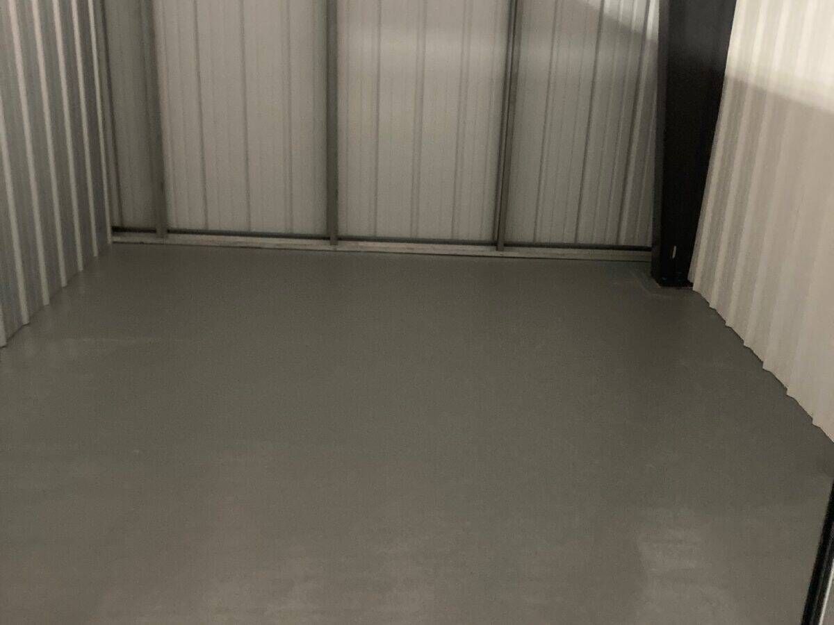 A small room with a gray floor and white walls.