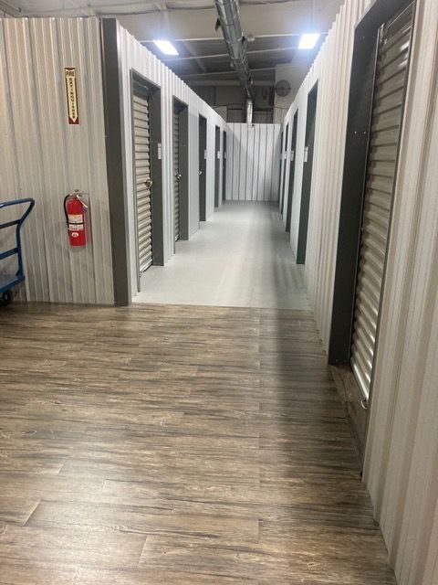 A man is loading boxes onto a cart in a storage room.