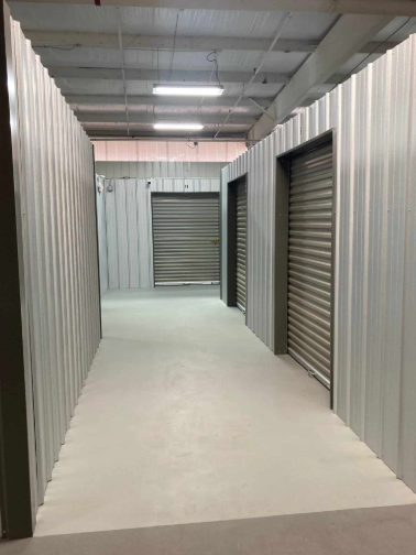 A row of blue and gray storage units with their doors open.