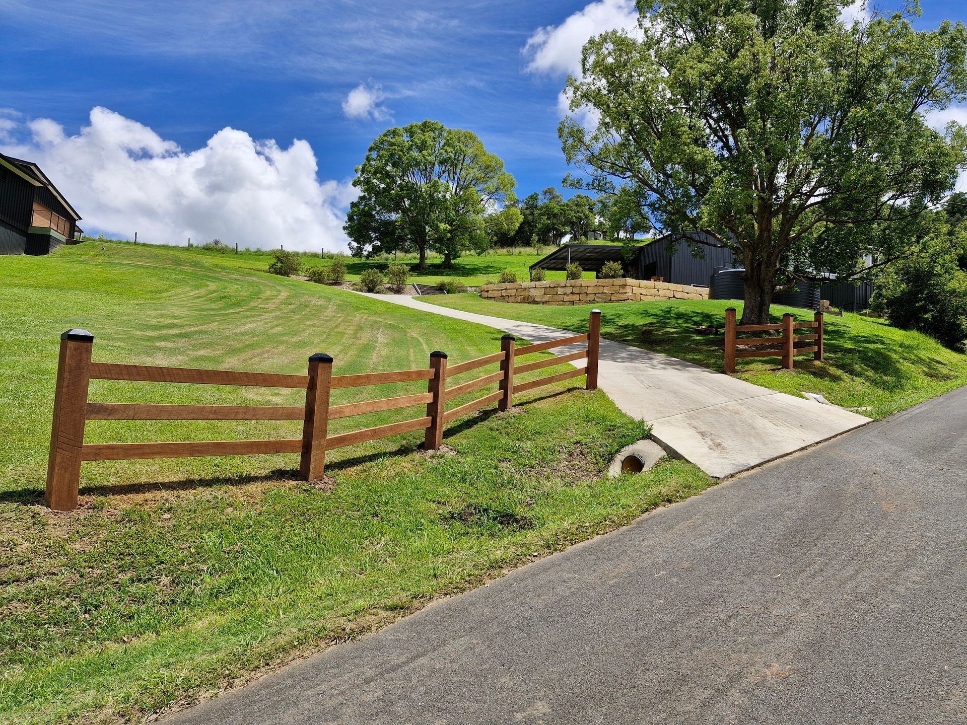 A Brown Fence at the Front Entrance with a Green Lawn — John Stark Fencing In West Woombye, QLD
