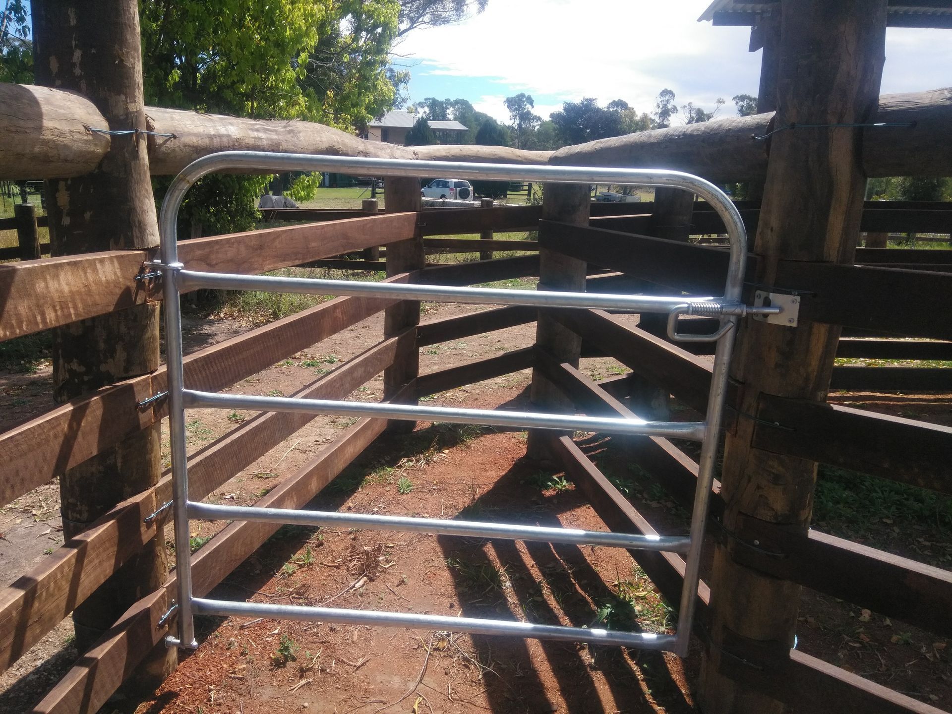 A Stable Wooden Fence With A Metal Gate— John Stark Fencing In West Woombye, QLD
