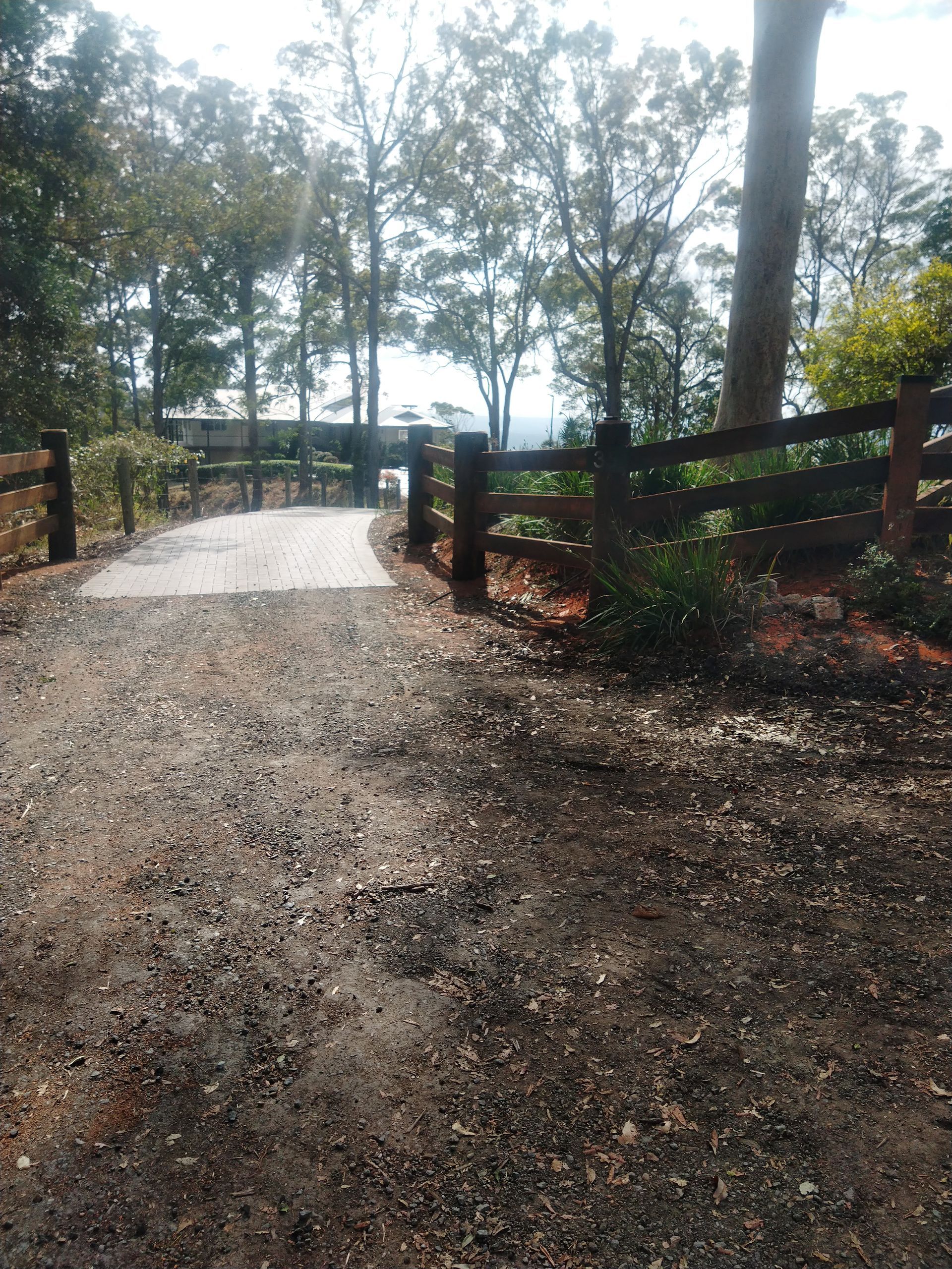 A Driveway Next To Wooden Fence Surrounded By Trees — John Stark Fencing In West Woombye, QLD