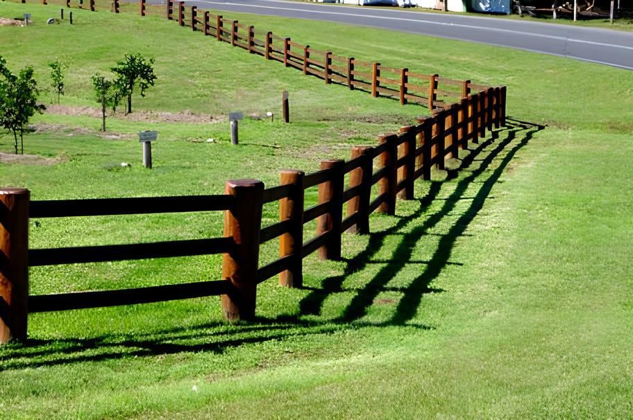 A Wooden Fence Surrounds A Lush Green Field — John Stark Fencing In West Woombye, QLD