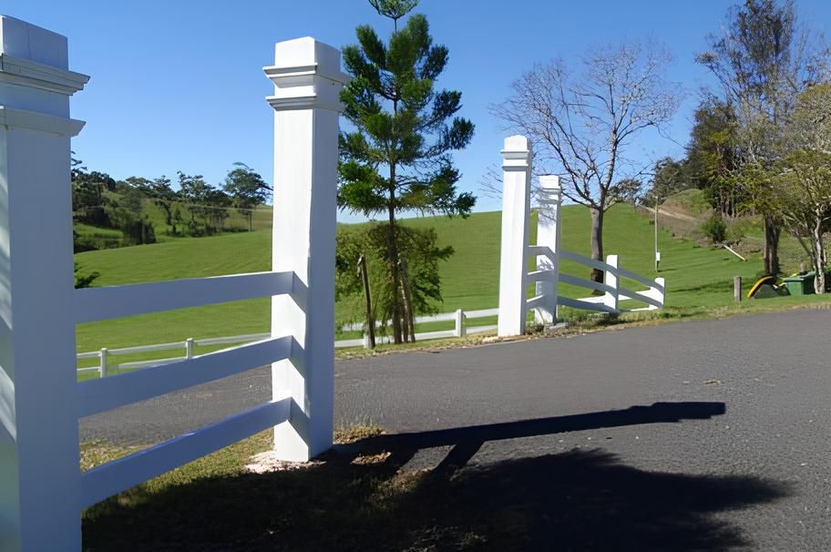 A White Fence With A Grassy Field In The Background — John Stark Fencing In West Woombye, QLD