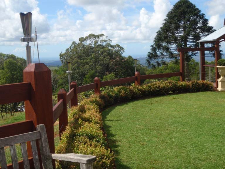 A Wooden Fence Surrounds A Lush Green Field — John Stark Fencing In West Woombye, QLD