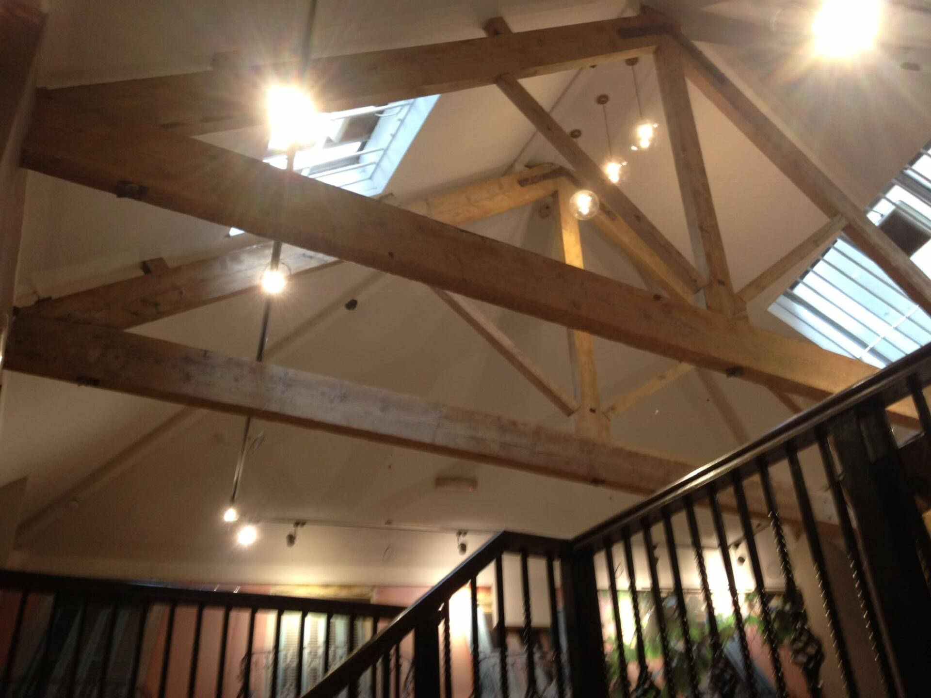 Modern lighting overhanging traditional wooden beams