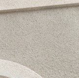 Tan textured wall with a slight architectural detail at the top and bottom.