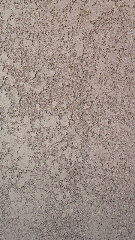 Textured beige stucco wall.