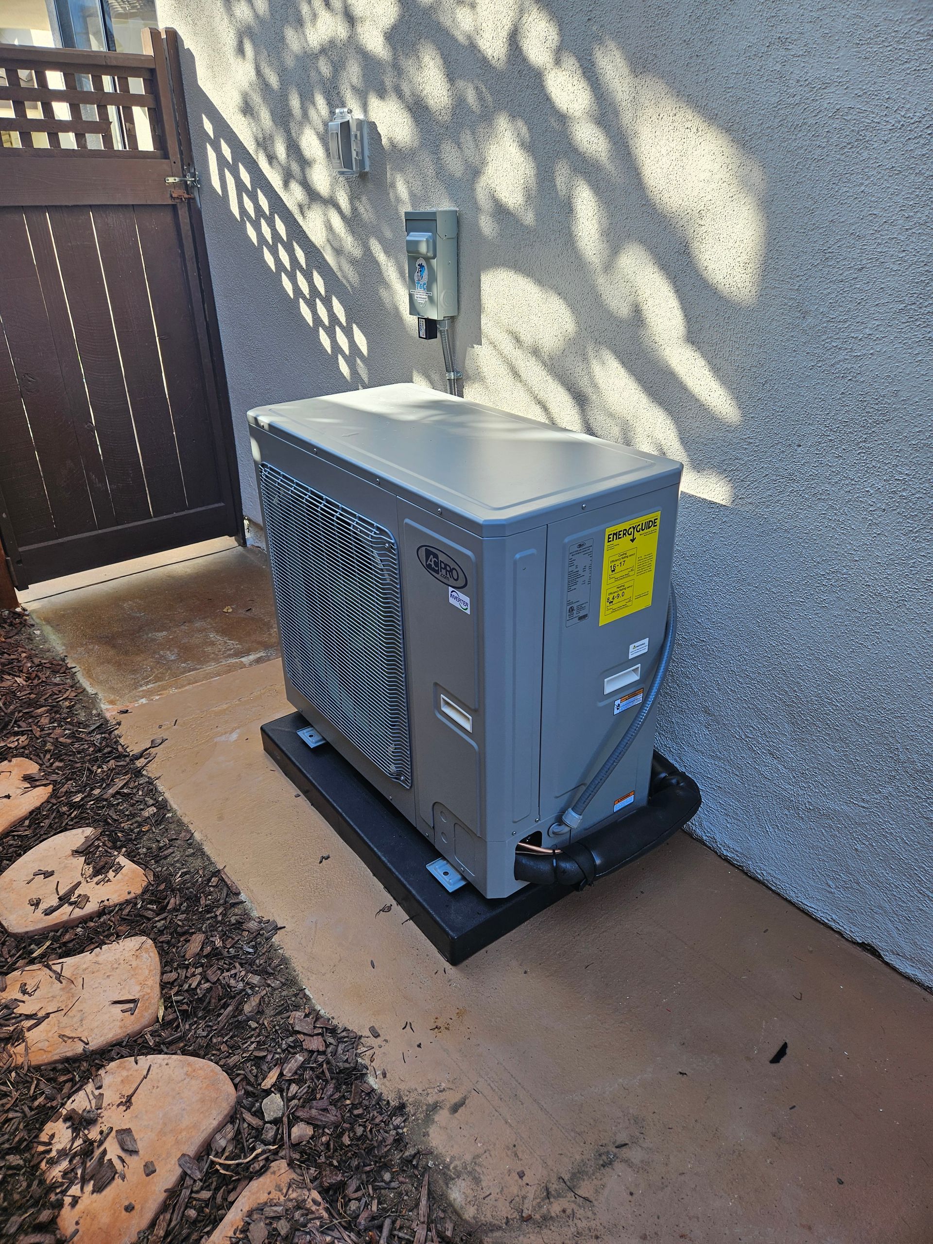 A large air conditioner is sitting on the side of a building.