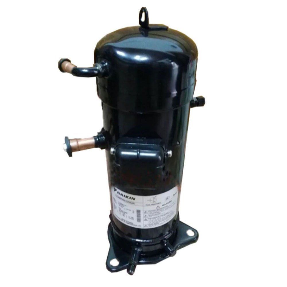 A black compressor is sitting on a white surface.