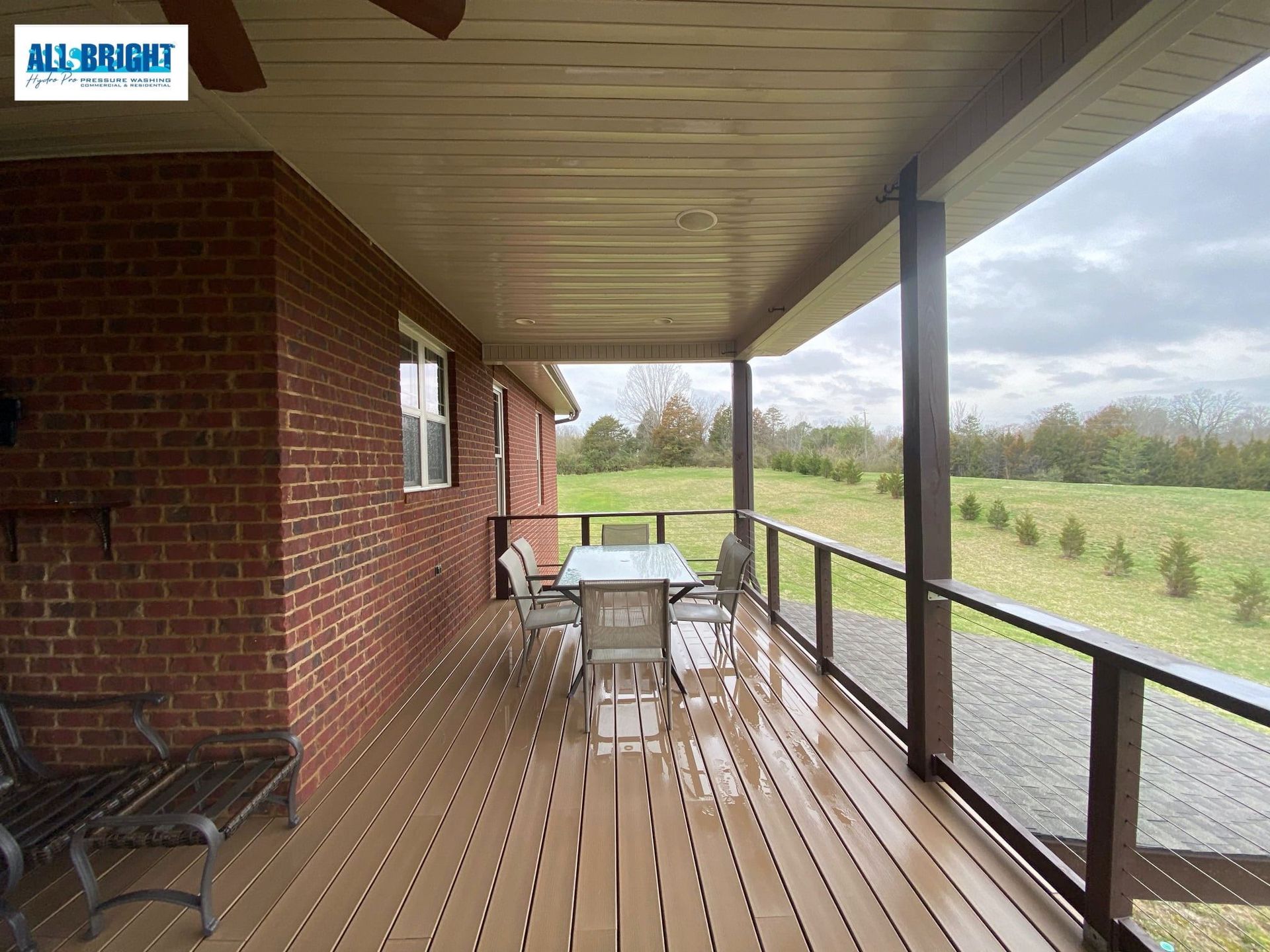 A brick house with a screened in porch with a table and chairs