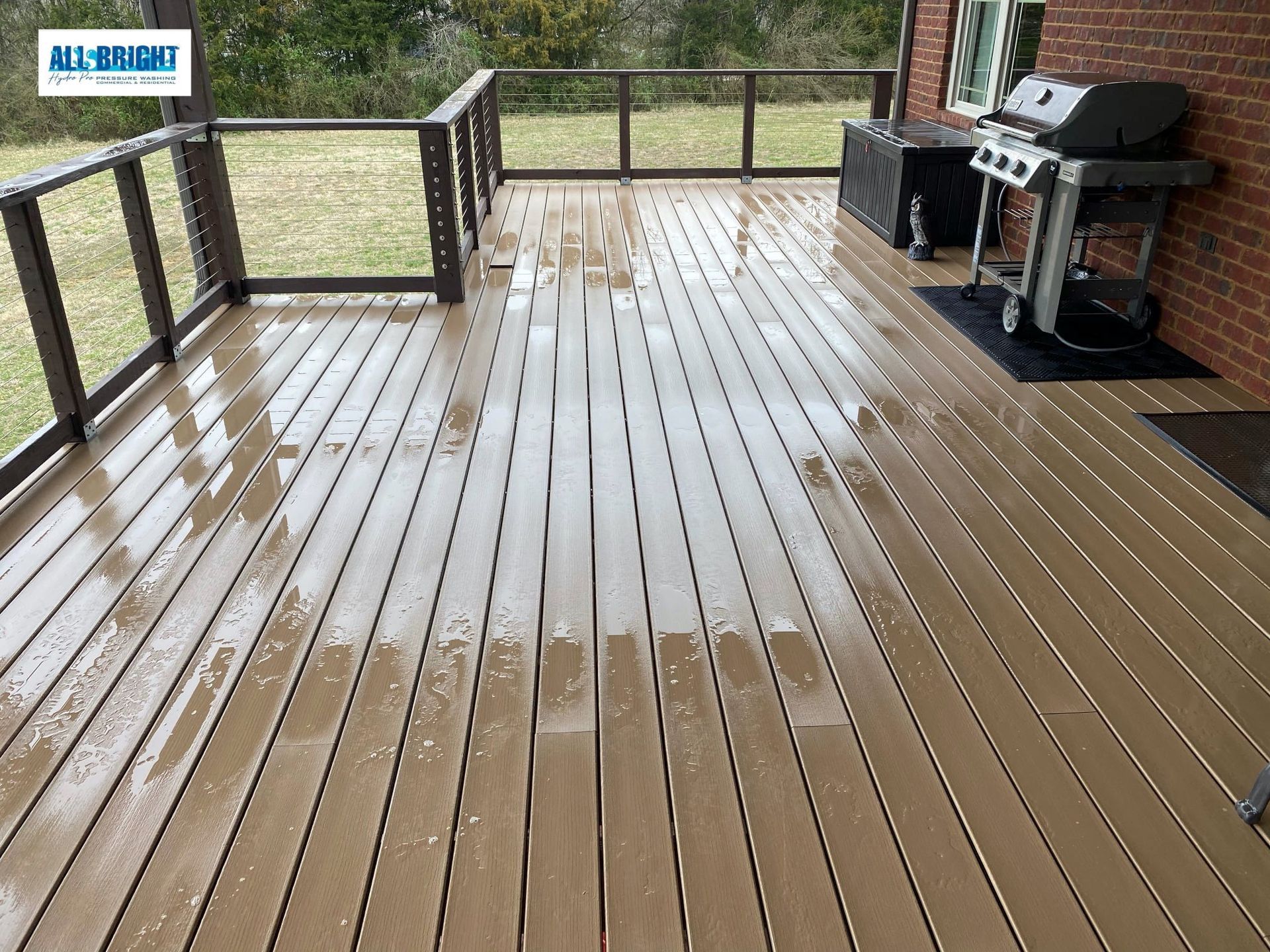 A wooden deck with a grill and a sign that says all bright