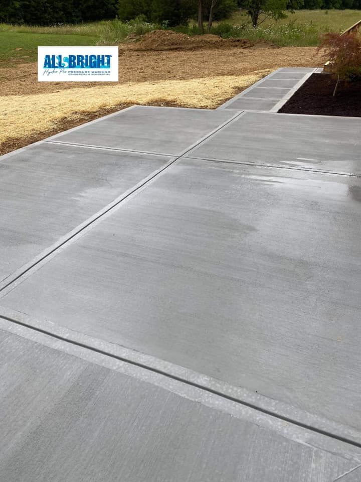 A concrete driveway with a sign that says `` all bright '' on it.