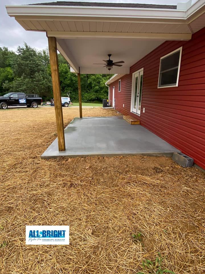 A red house with a covered porch and a ceiling fan.
