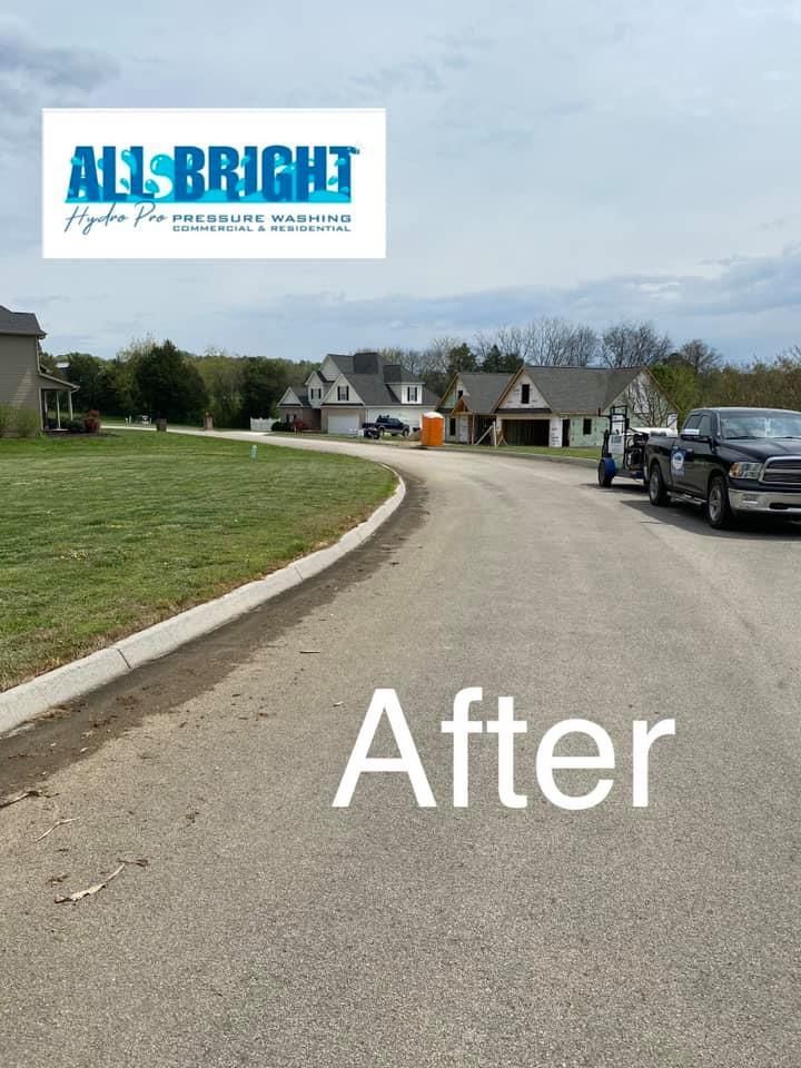 A picture of a street after being cleaned by all bright pressure washing.