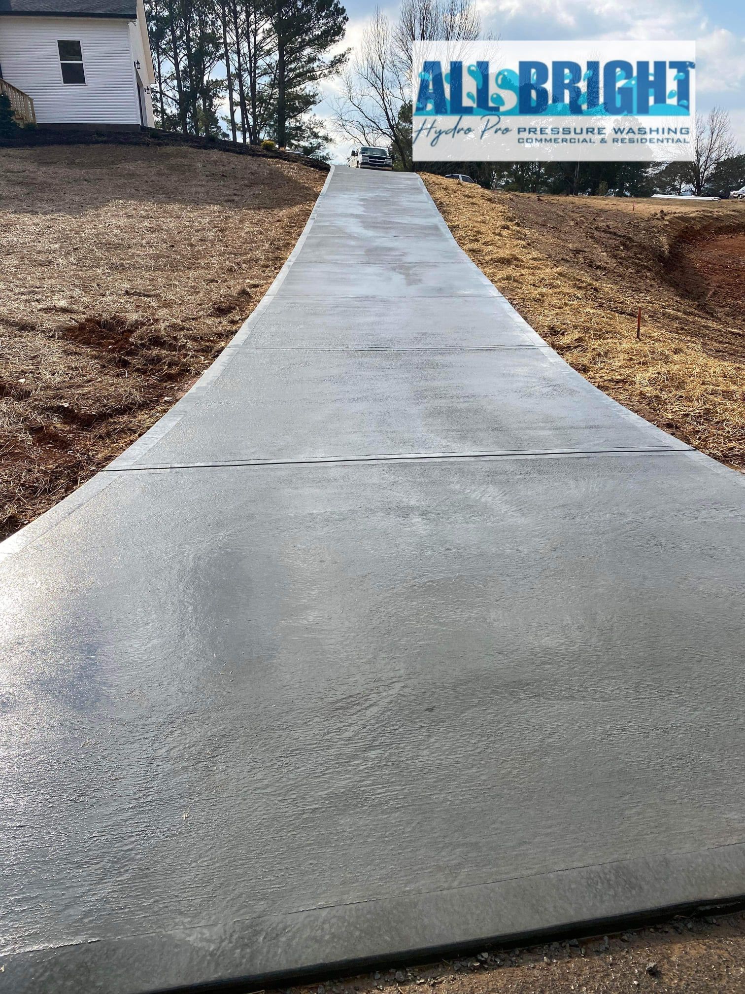 A concrete driveway is being built in front of a house.
