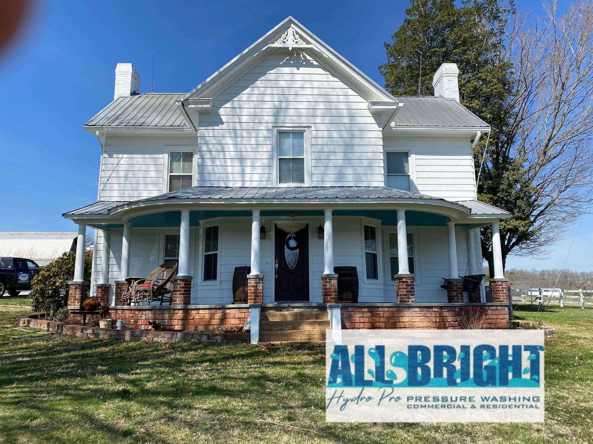 A white house with a blue porch and a sign that says `` all bright ''.