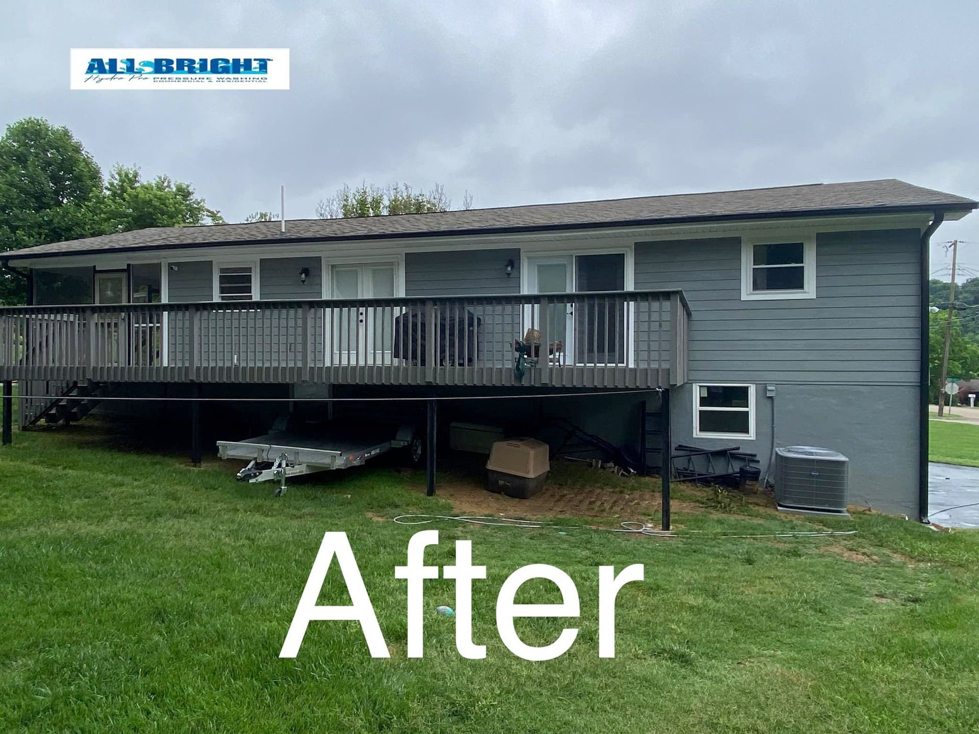 A picture of a house with a deck after being painted.