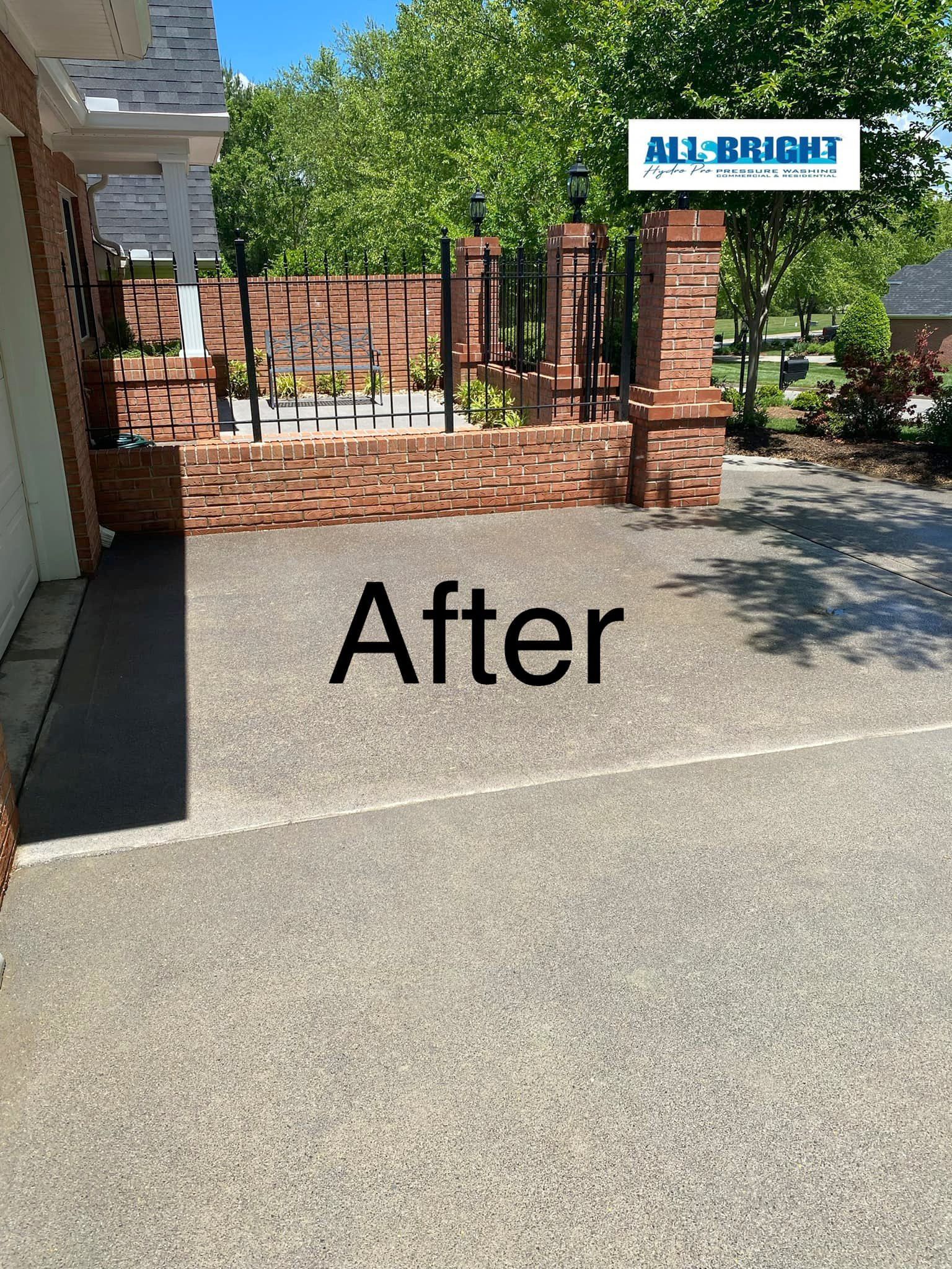 A picture of a driveway after being cleaned by a company.