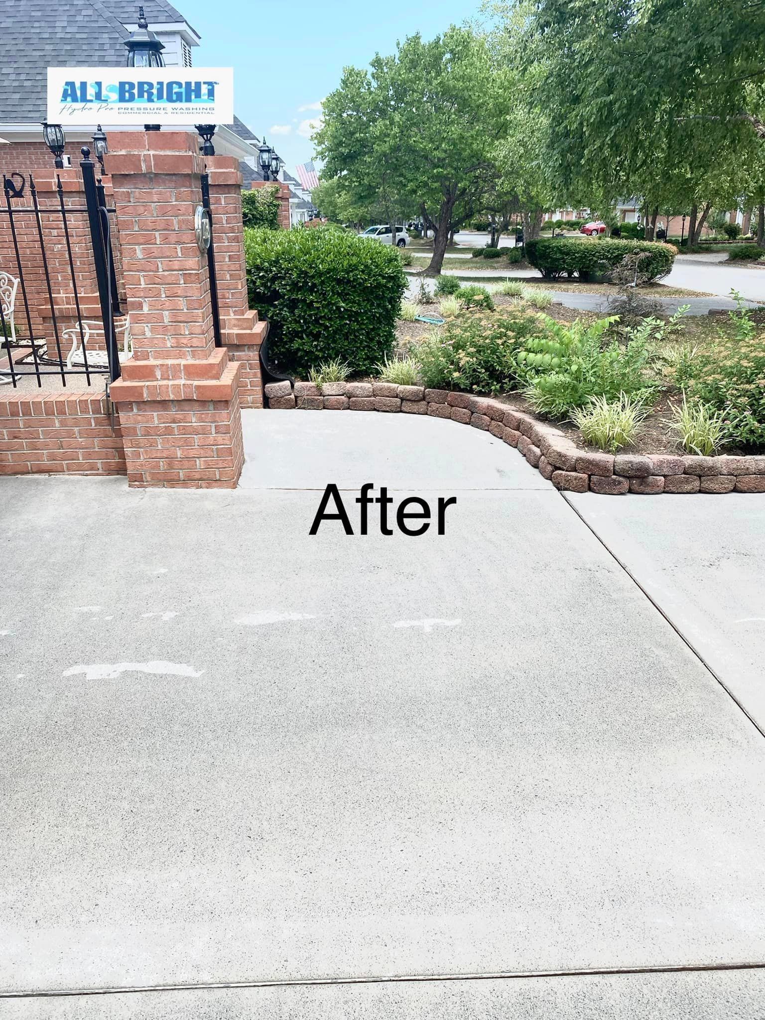 A concrete driveway with a brick wall and a sign that says `` after ''.