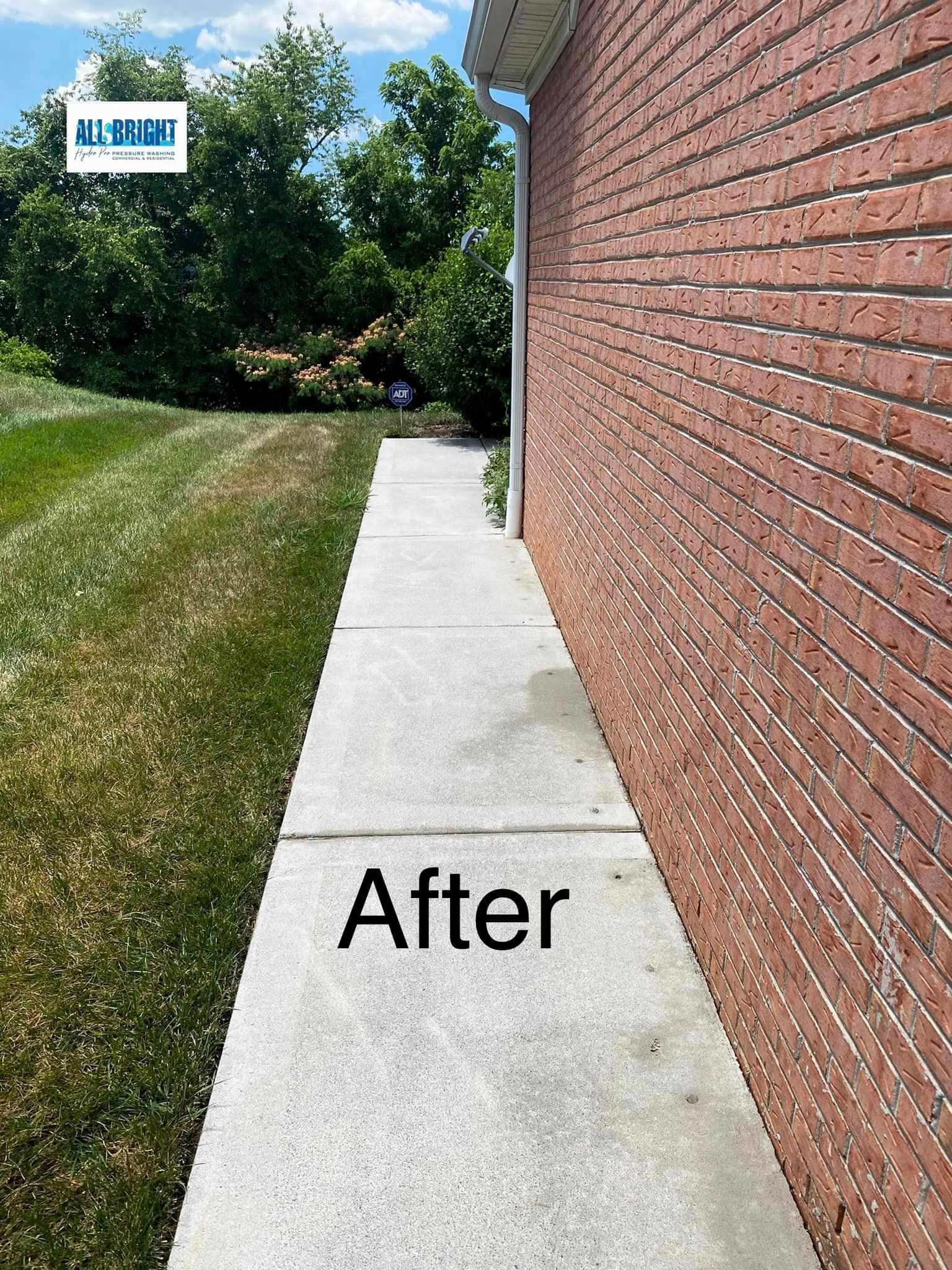 A sidewalk next to a brick wall with the words `` after '' written on it.