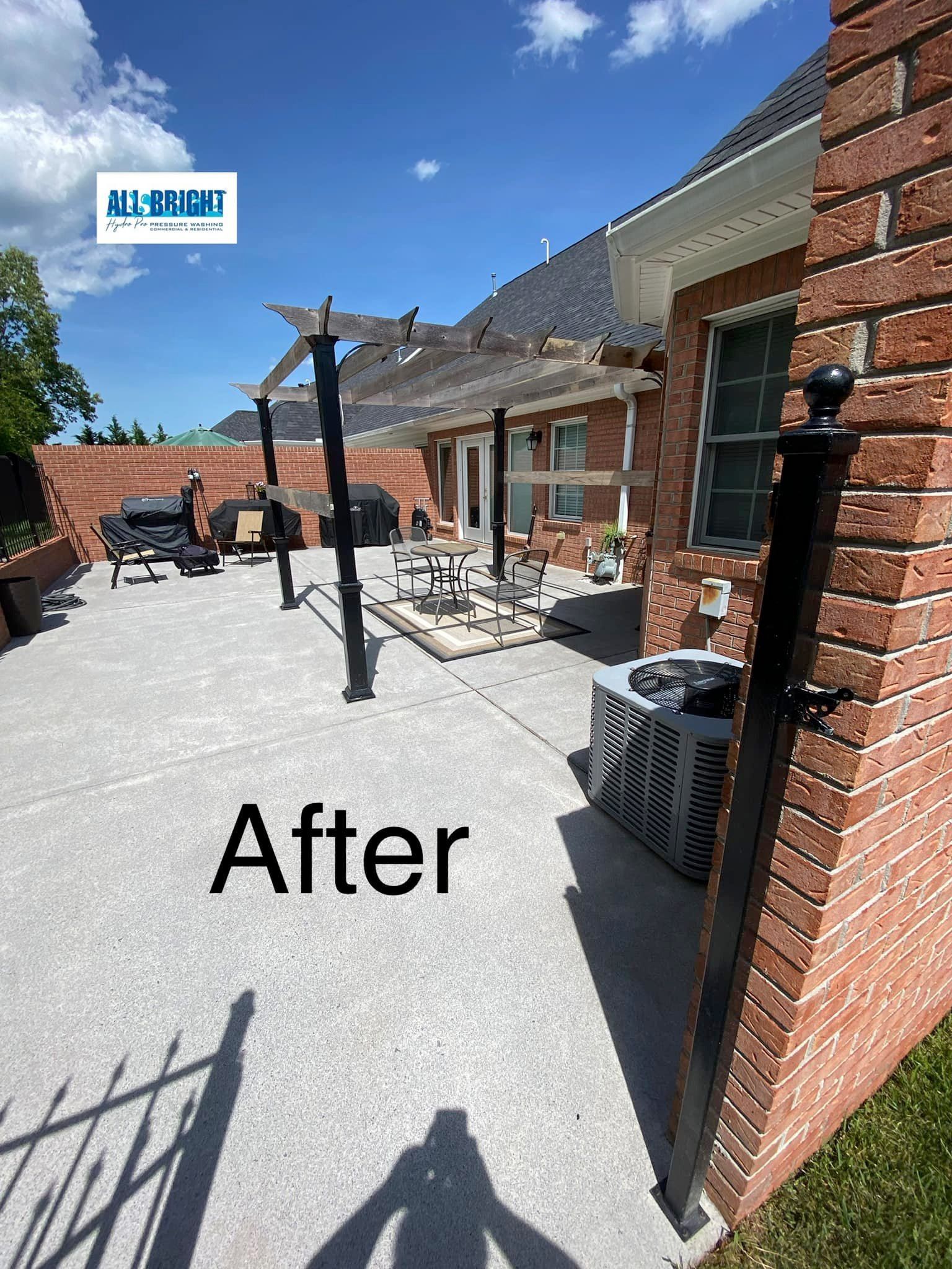 A picture of a brick house with a patio and a pergola.