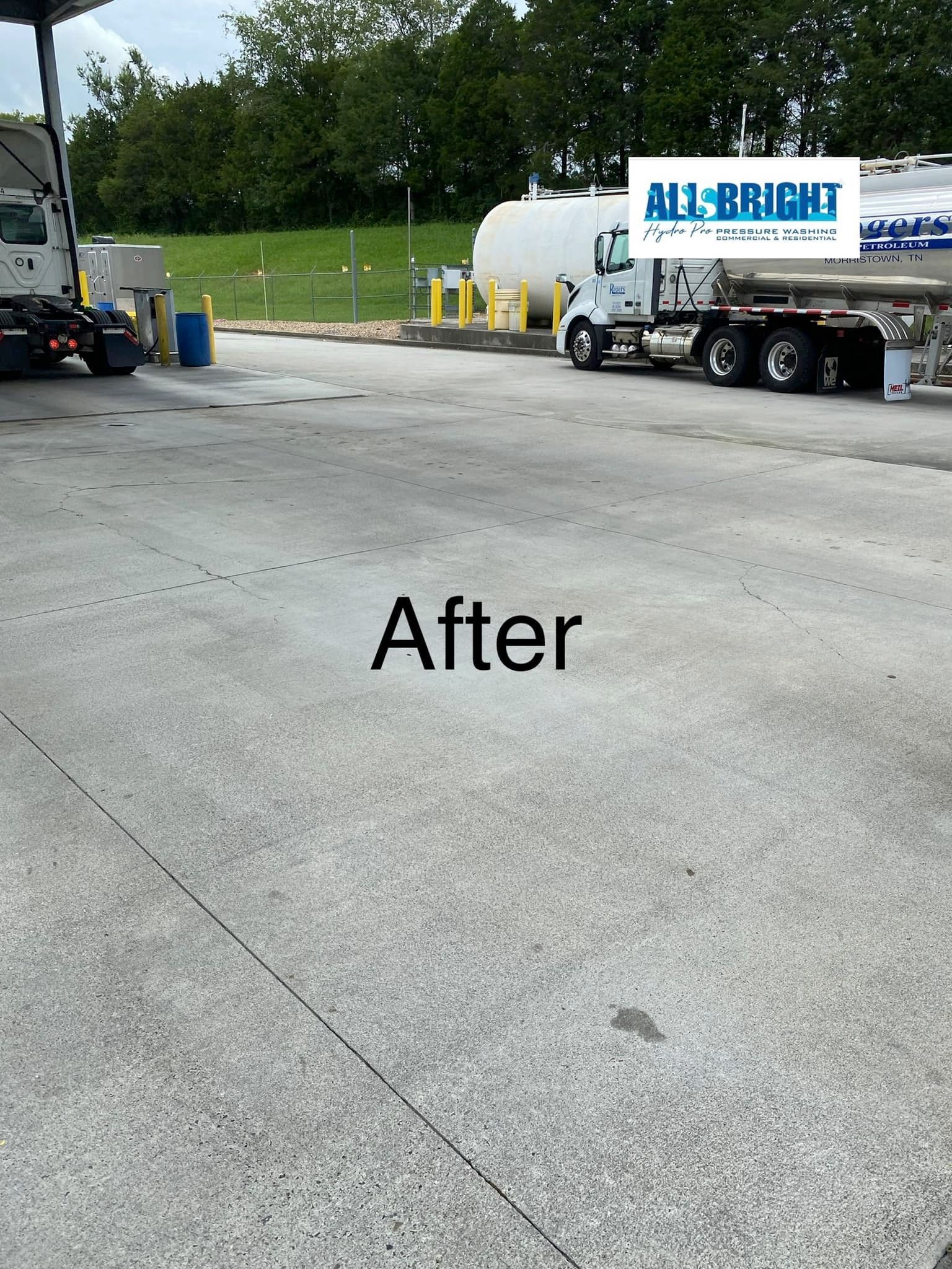 A truck is parked in a parking lot at a gas station.