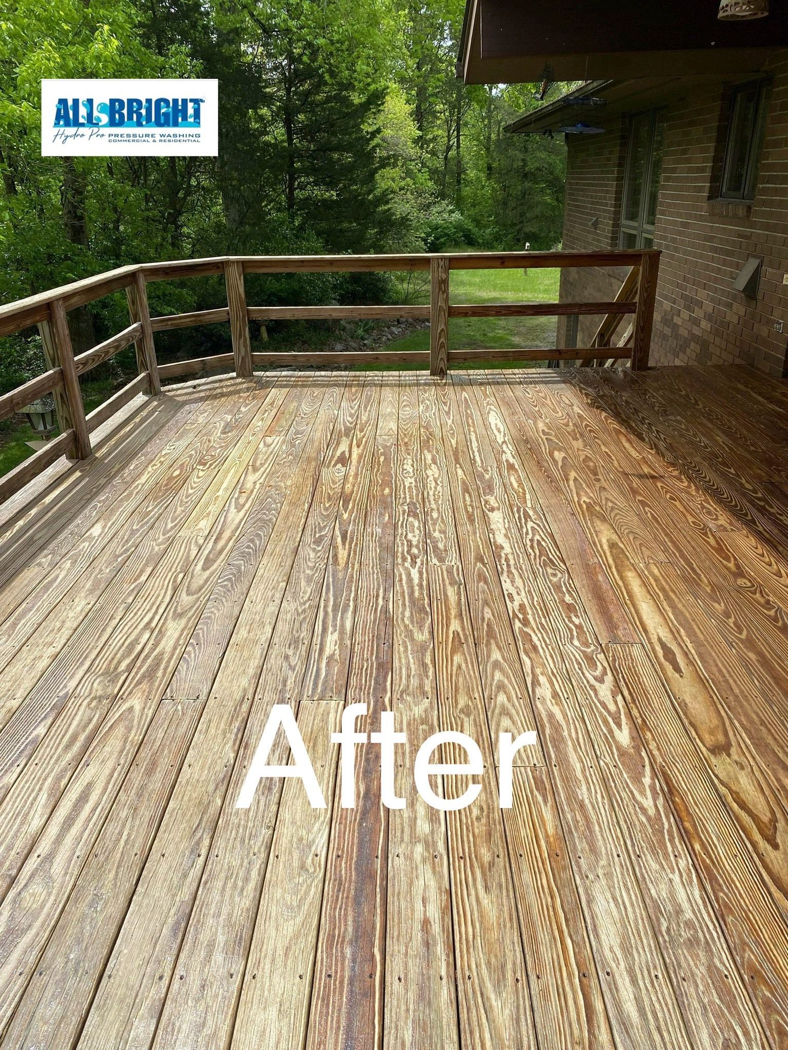 A wooden deck with a fence and trees in the background.