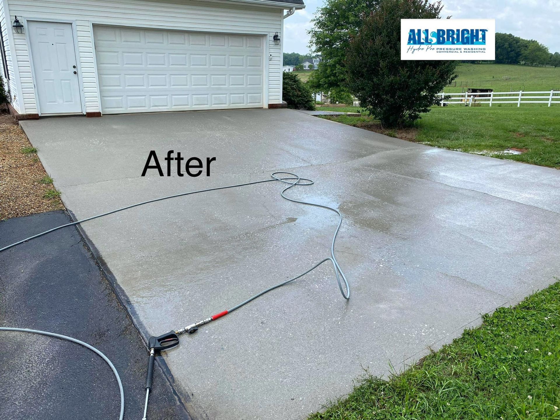 A driveway is being cleaned with a pressure washer.