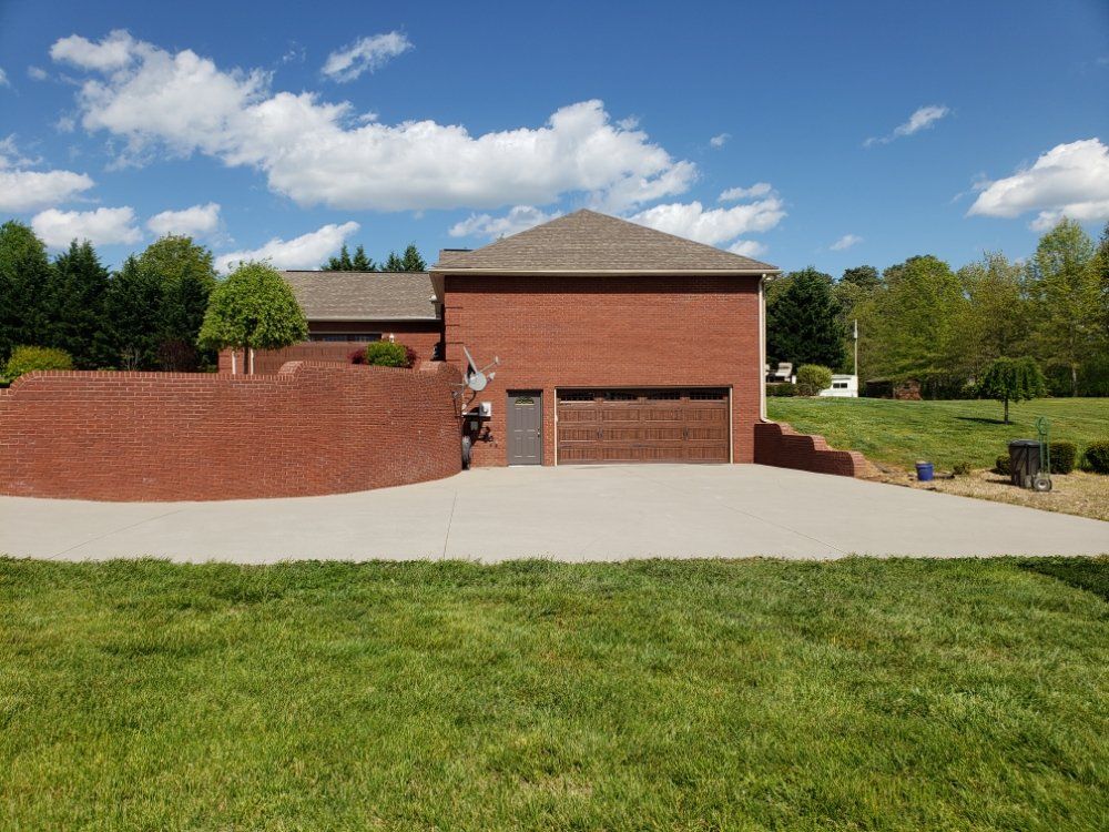 A large brick house with a garage and a driveway