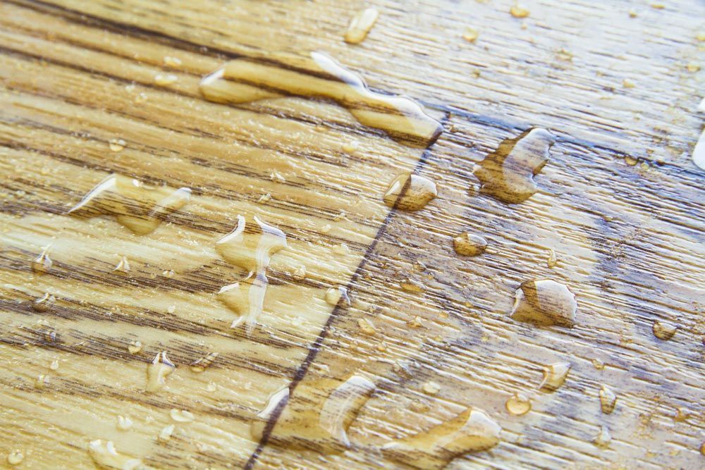 A Close Up Of A Wooden Surface With Water Drops On It — Affordable Carpets Woolgoolga In Northern Rivers, NSW