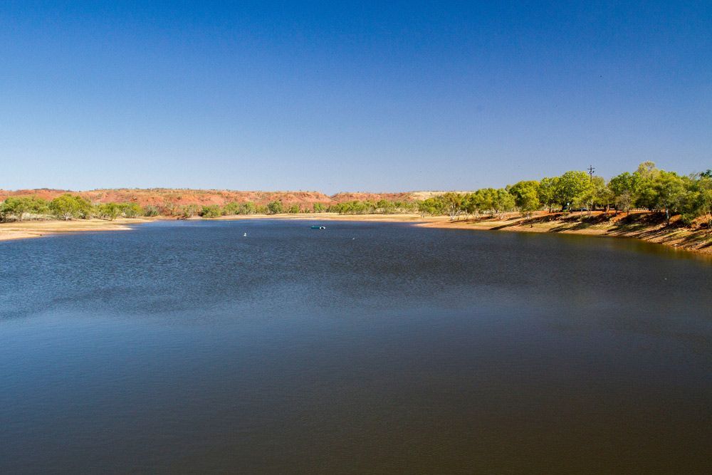 A Large Body Of Water Surrounded By Trees On A Sunny Day — Affordable Carpets Woolgoolga In Northern Rivers, NSW