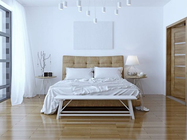 A Bedroom With A Bed, Bench, Nightstand , Lamp And Window — Affordable Carpets Woolgoolga In Woolgoolga, NSW