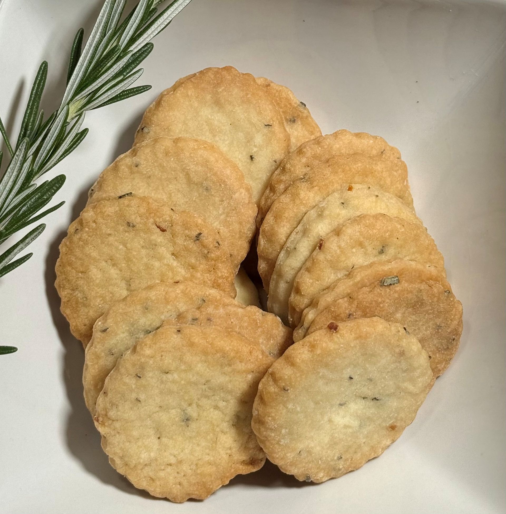 Package of rosemary lemon shortbread cookies, with label on a green and white striped background.