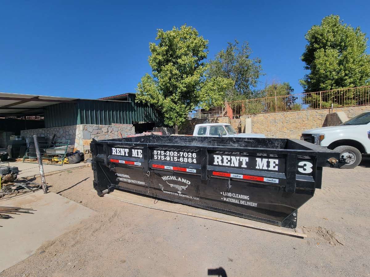 A dumpster that says rent me 3 on it