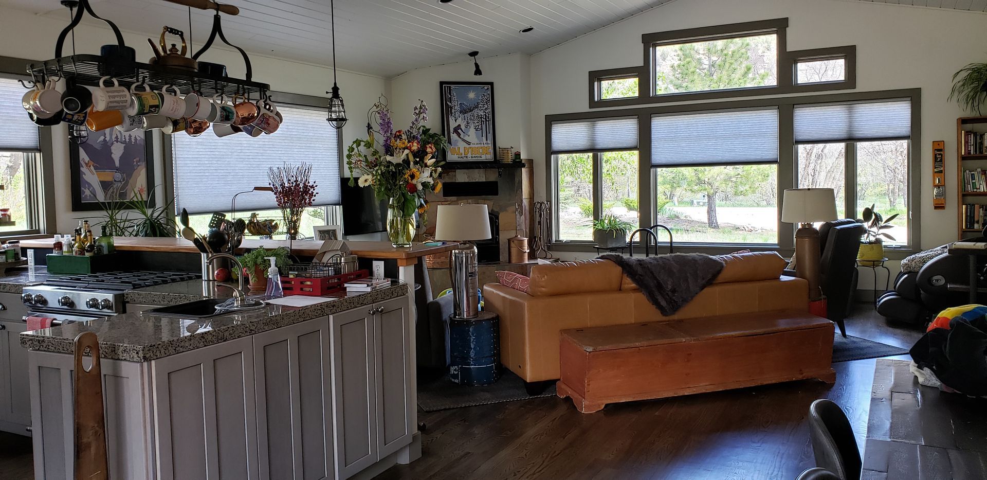 a living room with a huge window with cellular shades